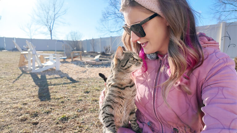 woman and cat in a garden