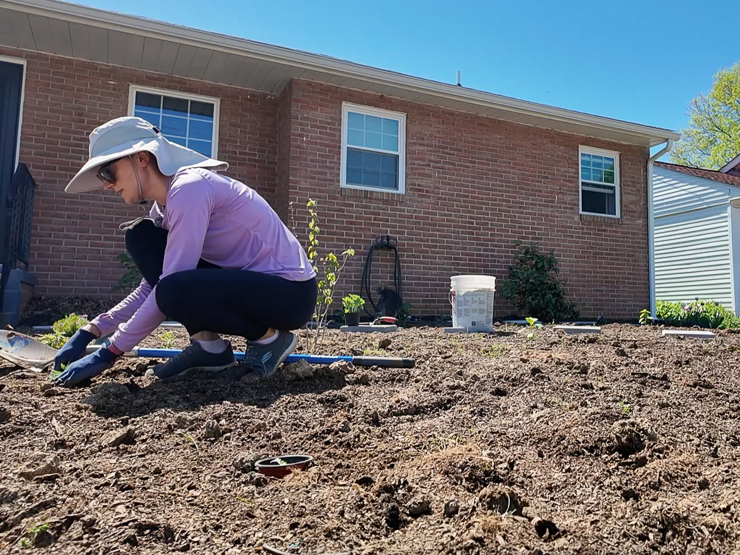 woman planting in a yard