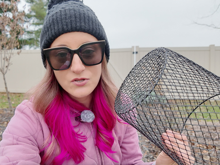 woman holding a wire plant cover