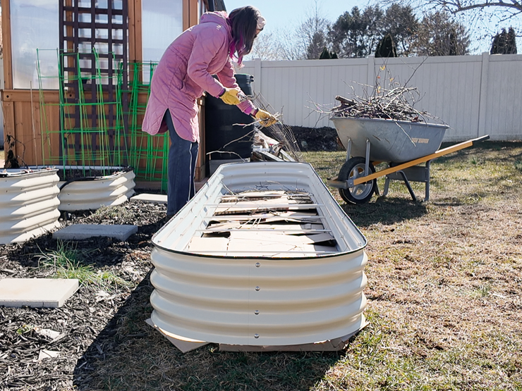 adding yard waste to a raised bed