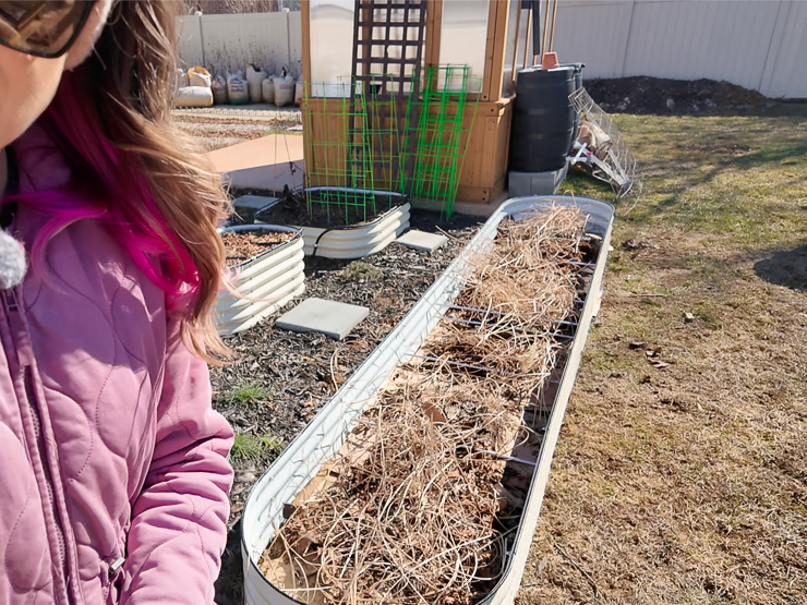 adding yard waste to a raised bed