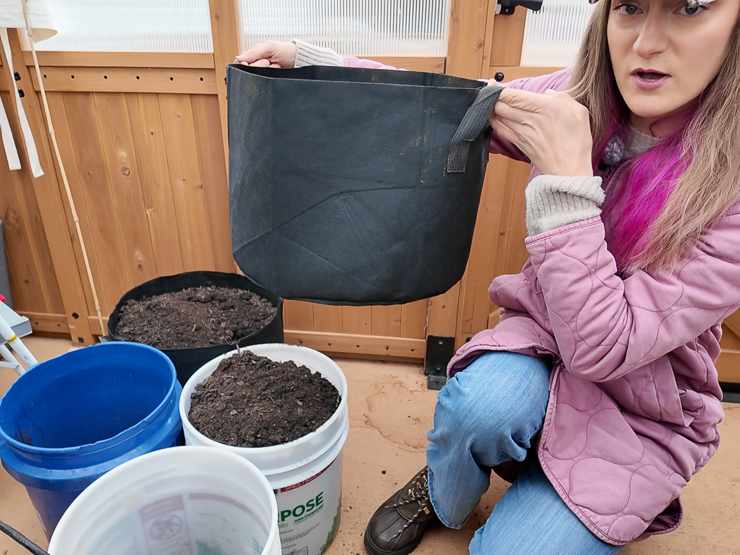 woman holding a grow bag