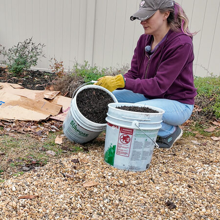 woman with buckets of compost