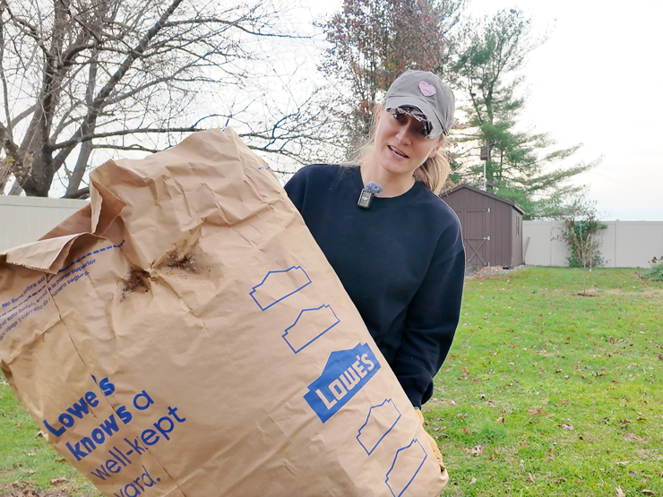 woman holding a bag of leaves