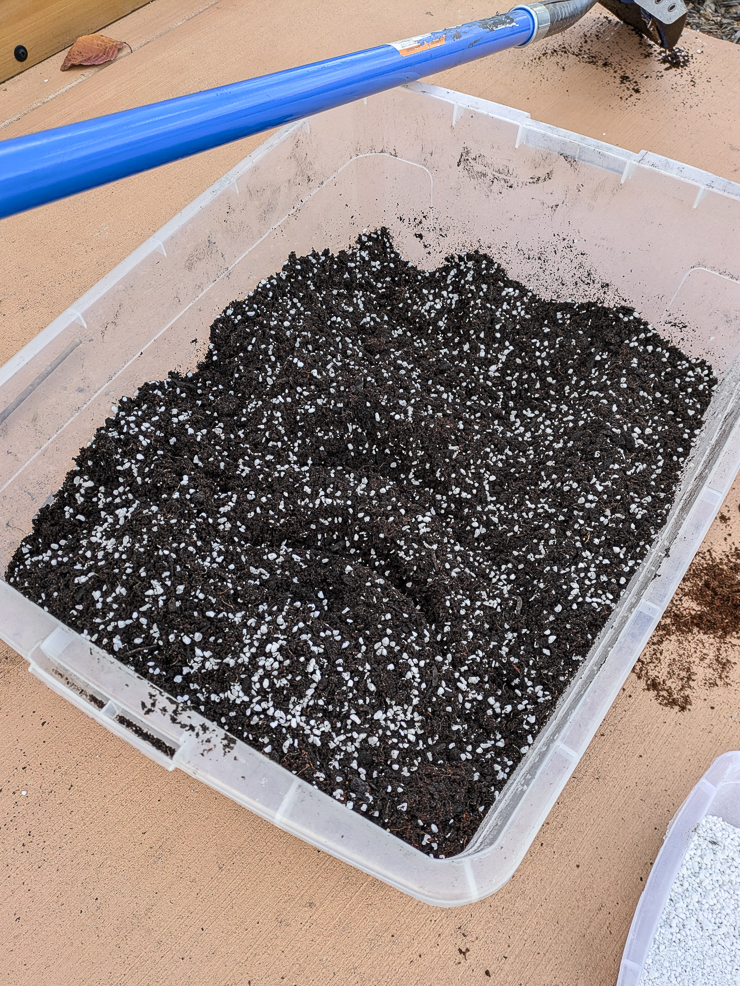 homemade potting soil in a large plastic tub