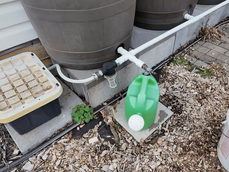 watering can under a rain barrel